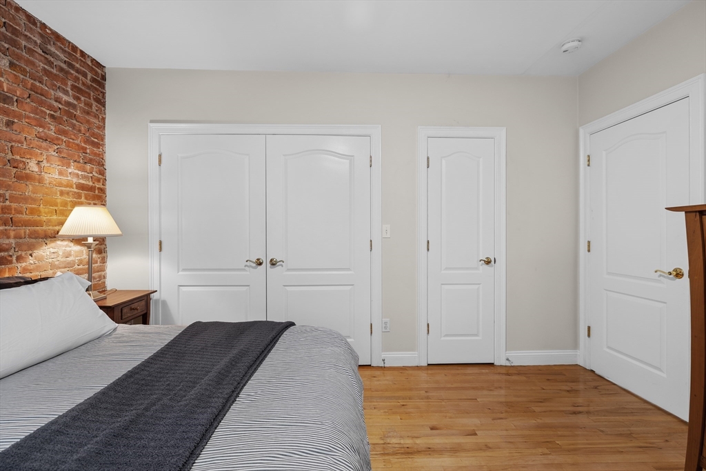 454 Hanover Street, Unit 5 Boston, MA 02113 - Photo 11 of 19 a view of a bedroom with a bed and wooden floor