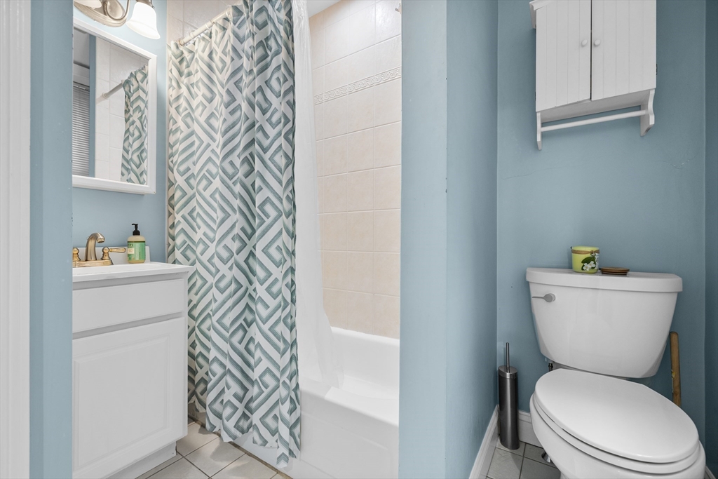 454 Hanover Street, Unit 5 Boston, MA 02113 - Photo 16 of 19 a white toilet sitting next to a bathroom sink