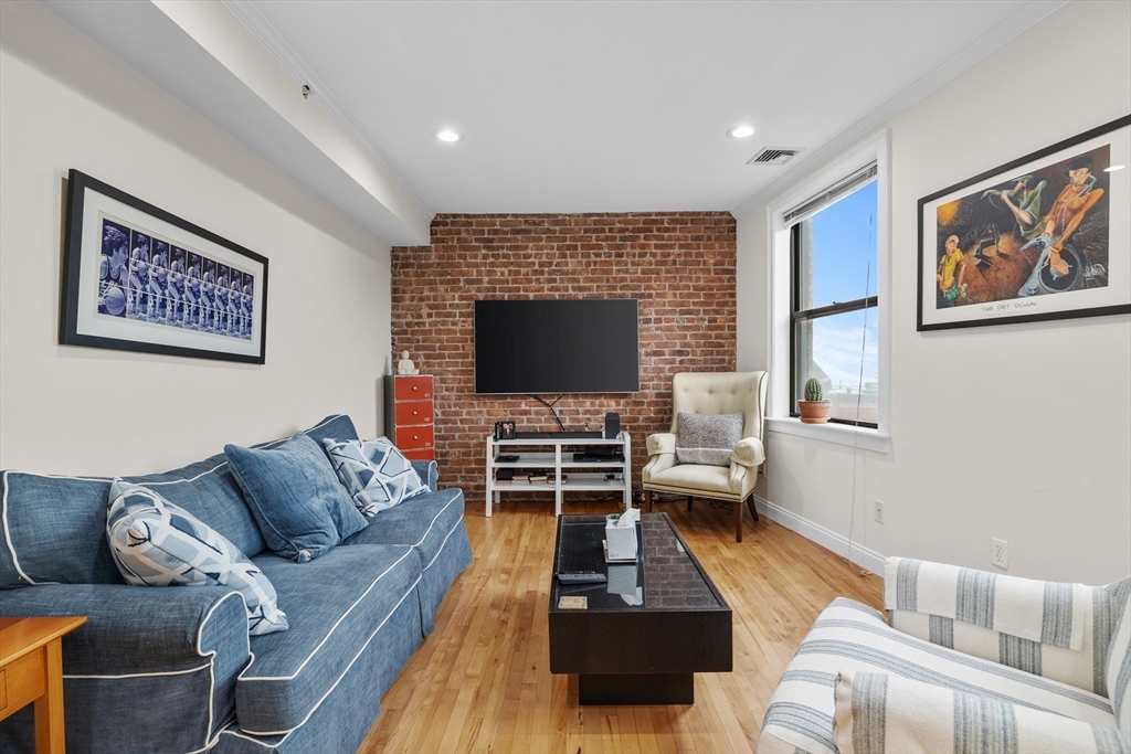 454 Hanover Street, Unit 5 Boston, MA 02113 - Photo 6 of 19 a living room with furniture flat screen tv and a window