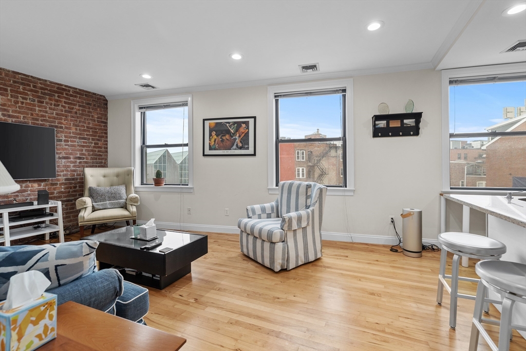 454 Hanover Street, Unit 5 Boston, MA 02113 - Photo 8 of 19 a living room with furniture and a flat screen tv