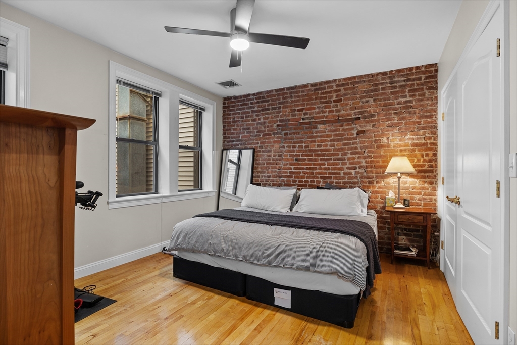 454 Hanover Street, Unit 5 Boston, MA 02113 - Photo 10 of 19 a bedroom with a bed and a chandelier