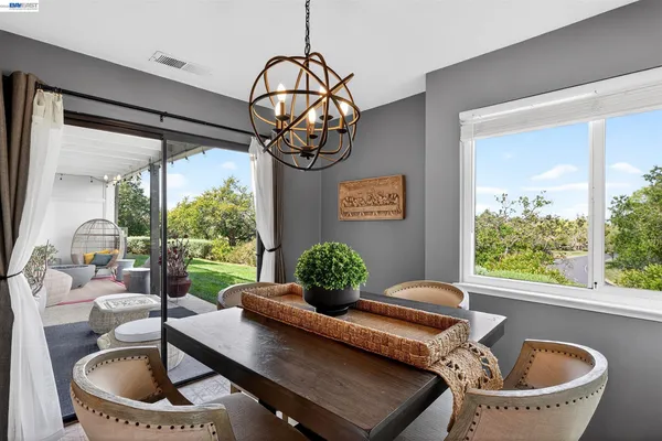 a living room with large window and furniture