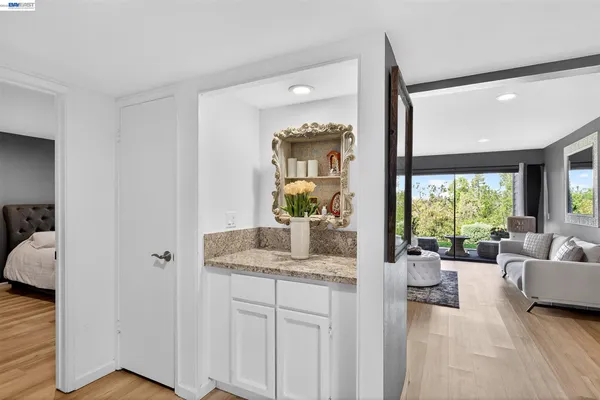 a spacious en suite bathroom with a granite countertop sink mirror and vanity