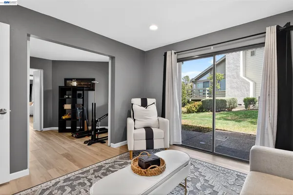a living room with furniture and a floor to ceiling window