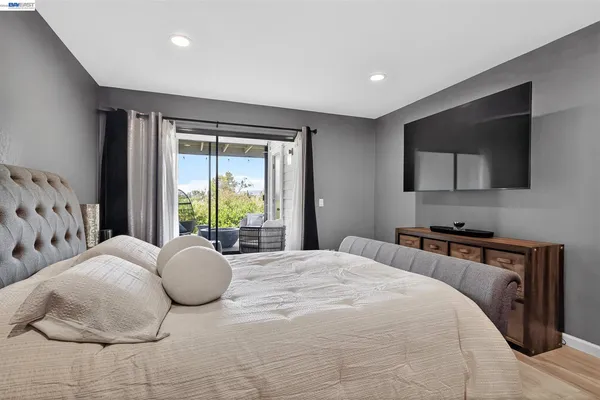 a bedroom with a bed and a flat screen tv