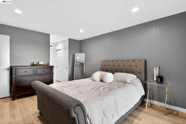 a bedroom with a bed and a lamp