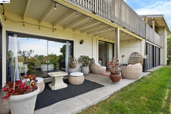 a view of a patio with couches and potted plants