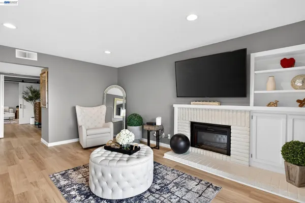 a living room with furniture a flat screen tv and a fireplace