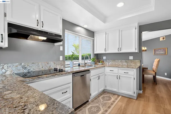 a kitchen with a sink stove and cabinets
