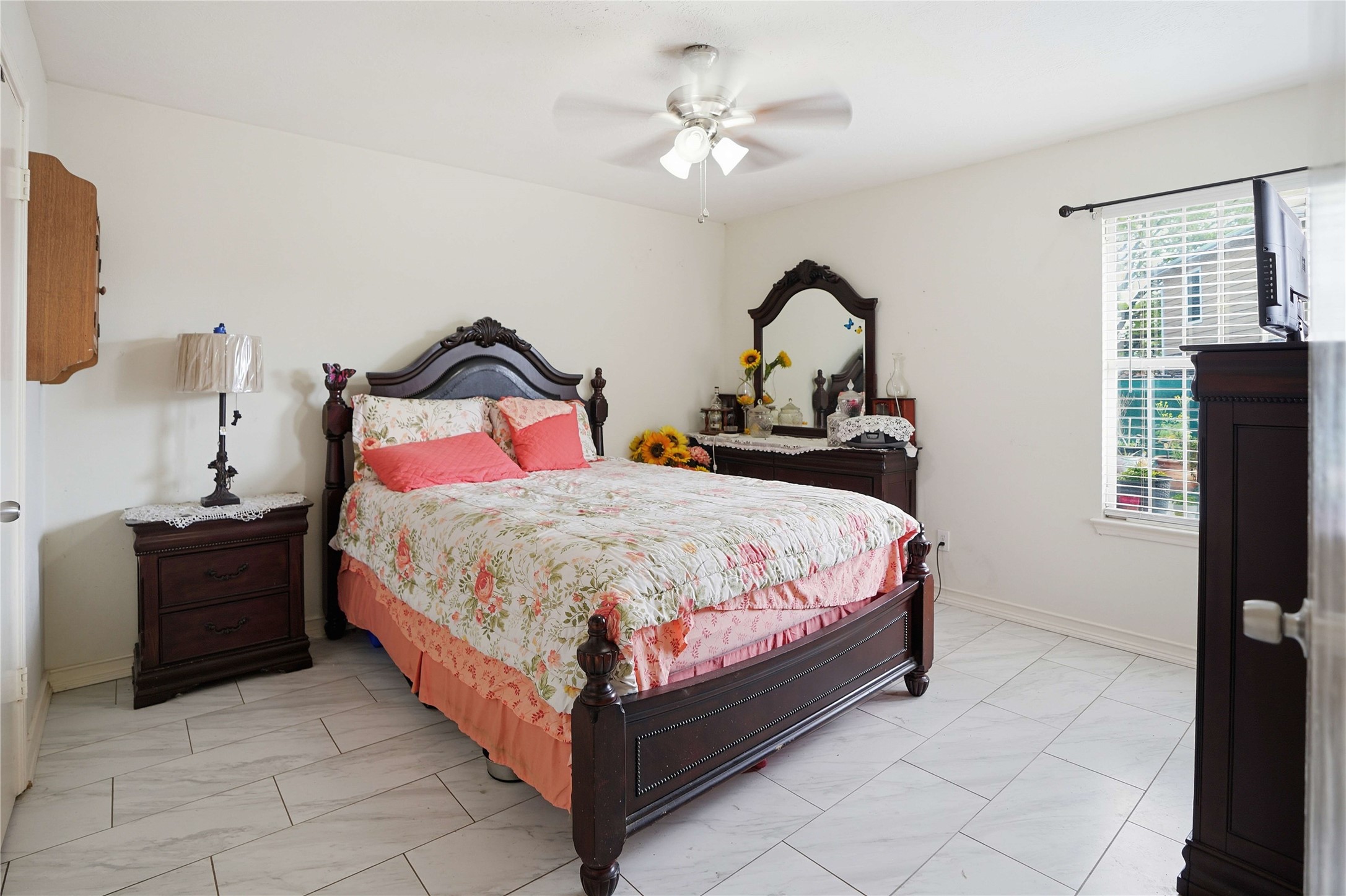 15258 Ferness Lane Channelview, TX 77530 - Photo 9 of 16 a bed room with a bed and a chandelier