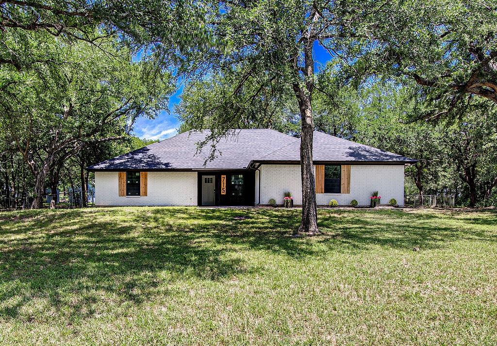 a house that has a tree in front of it