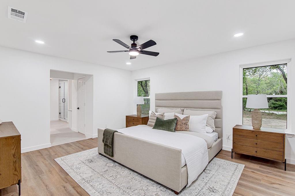 715 Pheasant Run Burleson, TX 76028 - Photo 13 of 28 a bedroom with a large bed and a chandelier