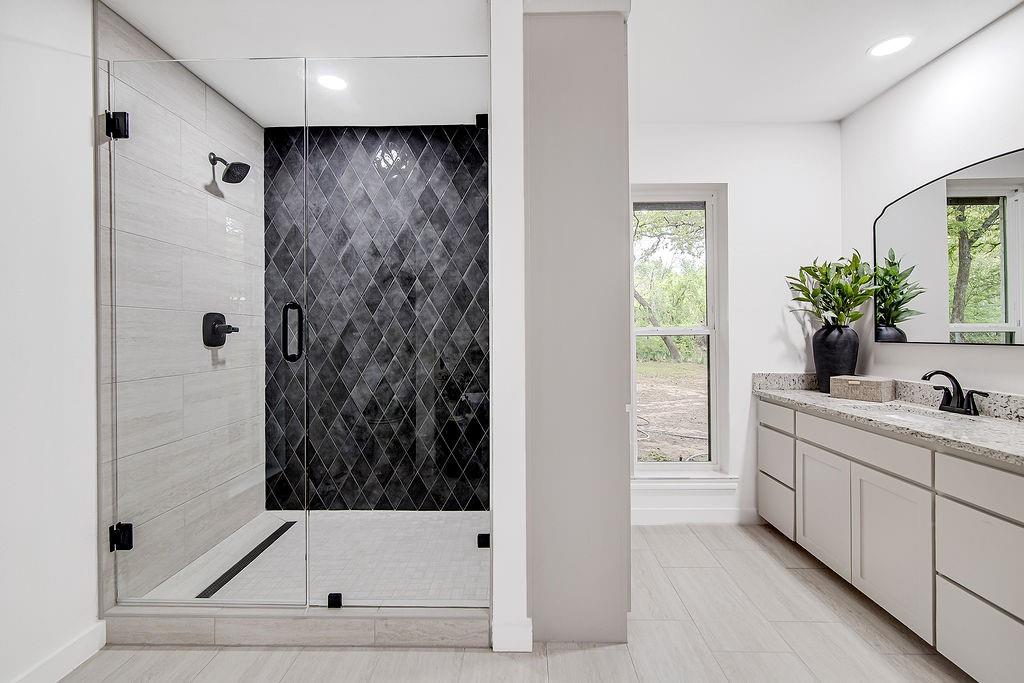 715 Pheasant Run Burleson, TX 76028 - Photo 16 of 28 a bathroom with a bathtub and a shower