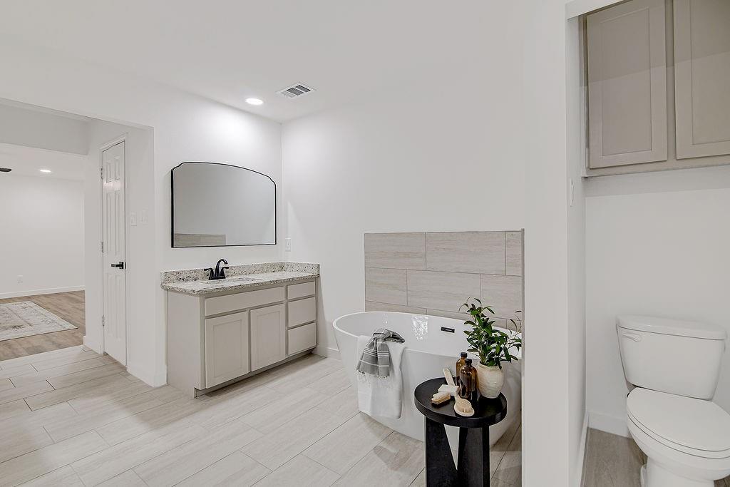 715 Pheasant Run Burleson, TX 76028 - Photo 17 of 28 a bathroom with a toilet sink and mirror