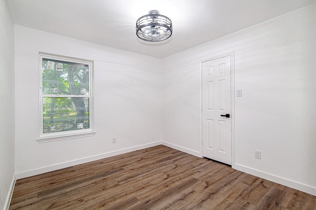 715 Pheasant Run Burleson, TX 76028 - Photo 20 of 28 an empty room with wooden floor and a window