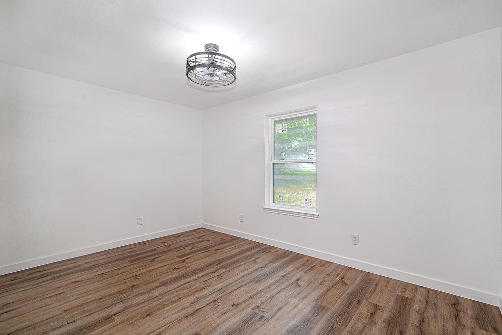 715 Pheasant Run Burleson, TX 76028 - Photo 21 of 28 an empty room with wooden floor and windows