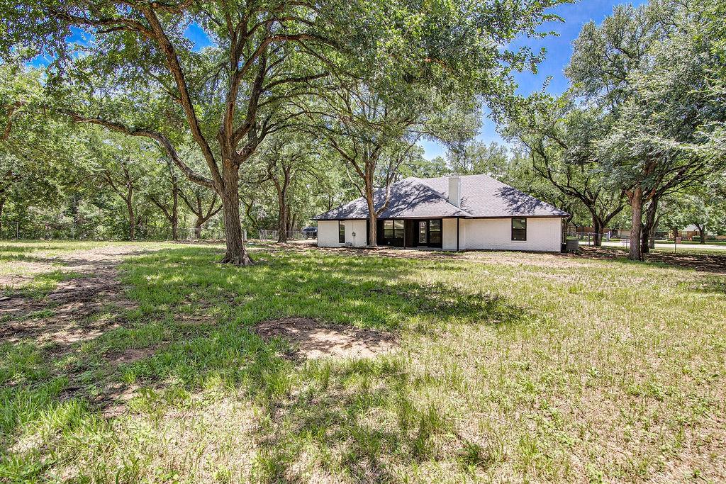 715 Pheasant Run Burleson, TX 76028 - Photo 23 of 28 a front view of a house with garden