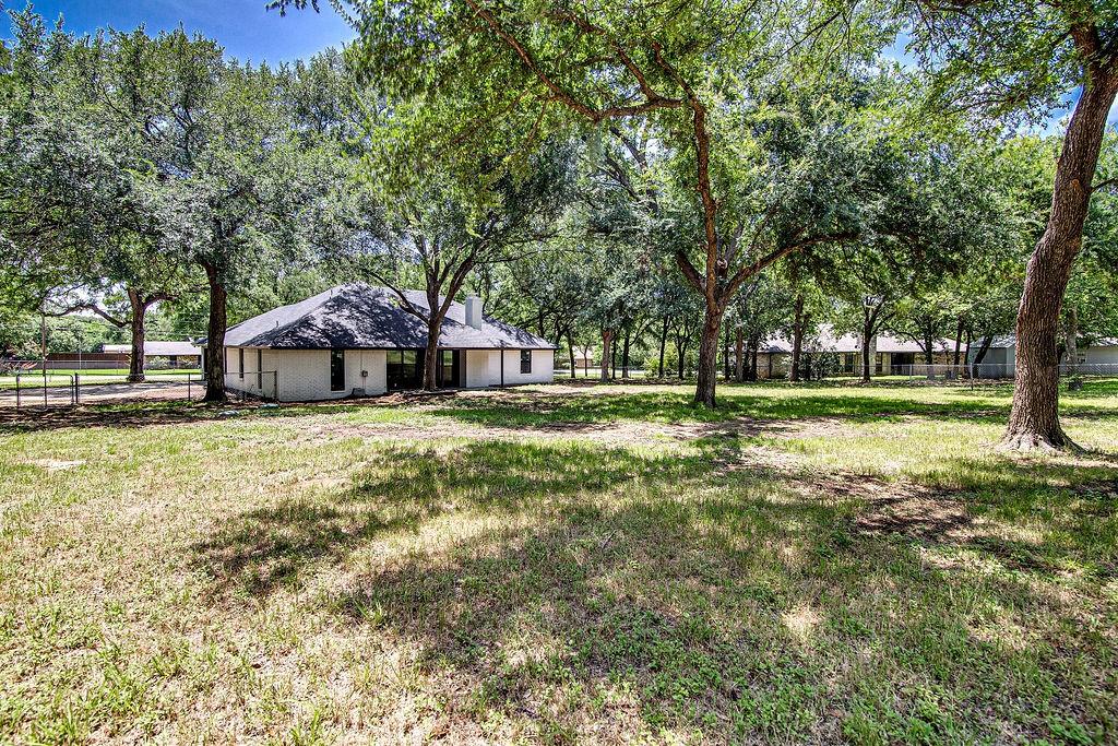 715 Pheasant Run Burleson, TX 76028 - Photo 24 of 28 a front view of a house with garden