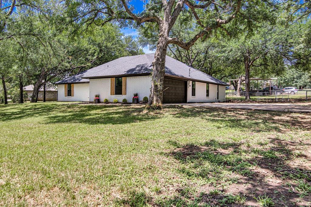 715 Pheasant Run Burleson, TX 76028 - Photo 27 of 28 a house that has a tree in front of it