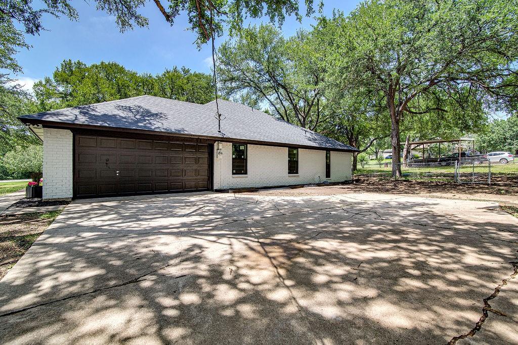 715 Pheasant Run Burleson, TX 76028 - Photo 28 of 28 a front view of a house with a garden