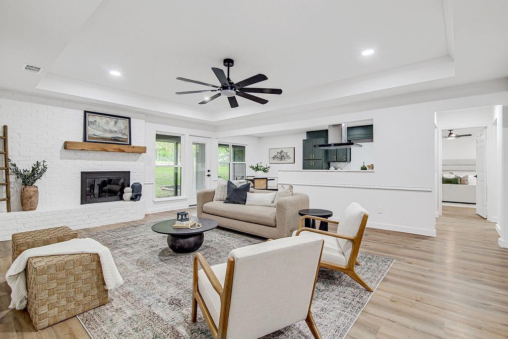 715 Pheasant Run Burleson, TX 76028 - Photo 3 of 28 a living room with furniture a fireplace and a flat screen tv