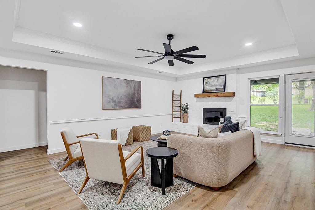 715 Pheasant Run Burleson, TX 76028 - Photo 4 of 28 a living room with furniture a fireplace and a large window