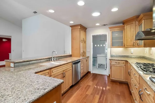 a kitchen with stainless steel appliances a refrigerator and a stove
