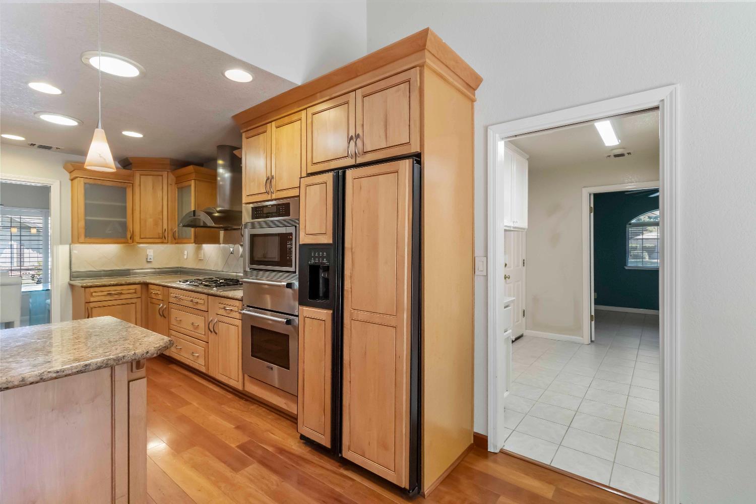 1311 Aberdeen Circle Granite Bay, CA 95746 - Photo 24 of 50 a kitchen with stainless steel appliances granite countertop a refrigerator and a stove top oven