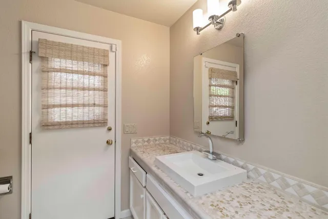 an empty room with windows and ceiling fan