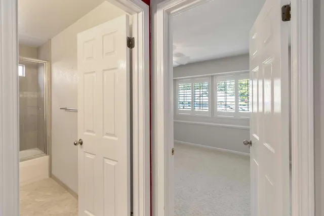 a view of an empty room with a fan