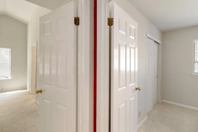 a view of empty room with ceiling fan