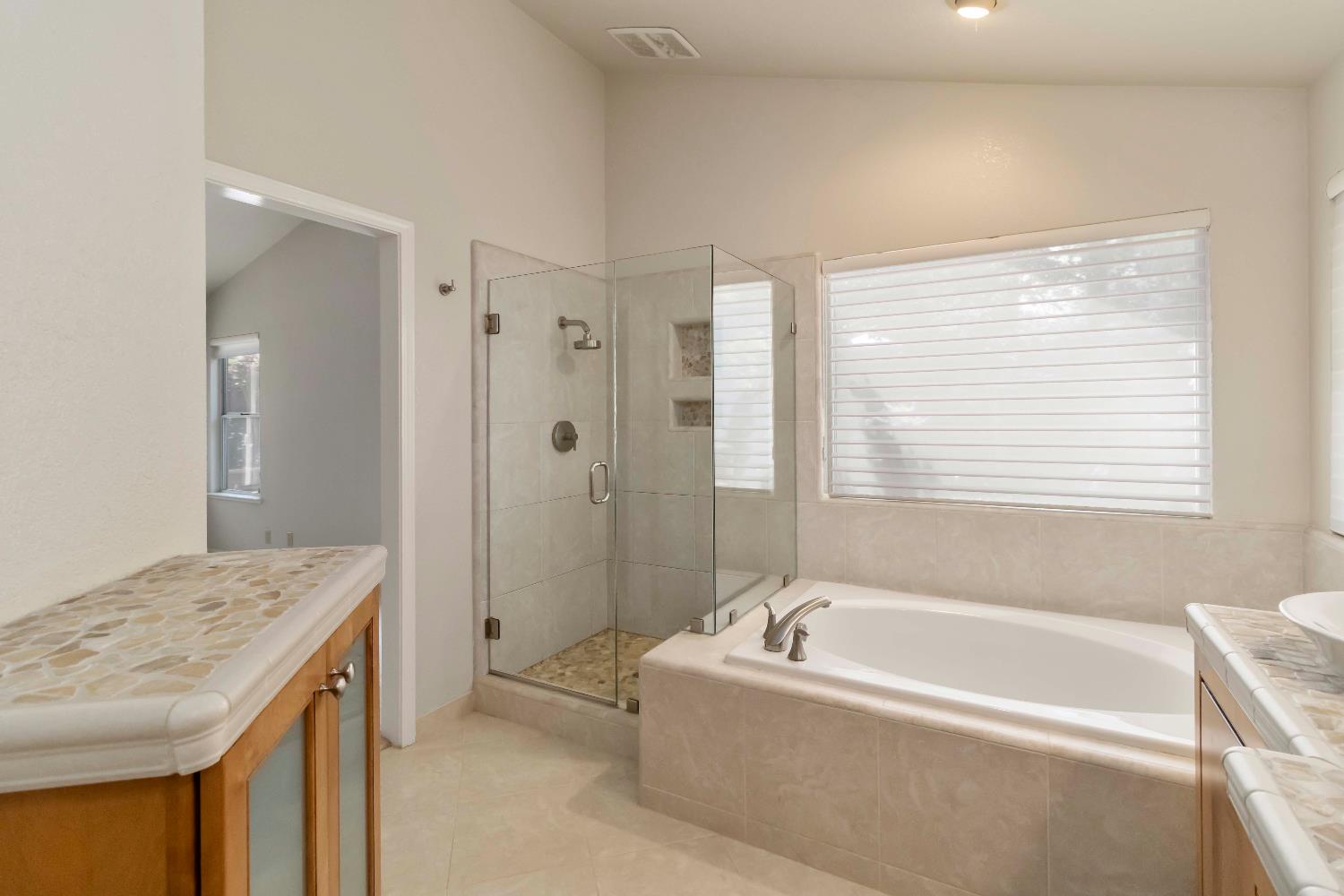 1311 Aberdeen Circle Granite Bay, CA 95746 - Photo 42 of 50 a bathroom with a granite countertop tub a sink and a shower