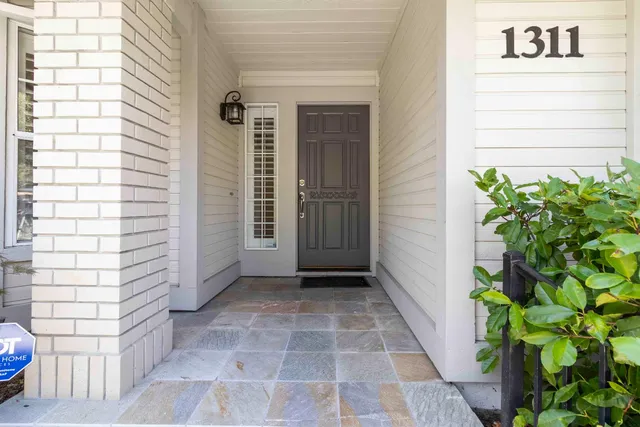 a view of a room with wooden floor and a bathroom