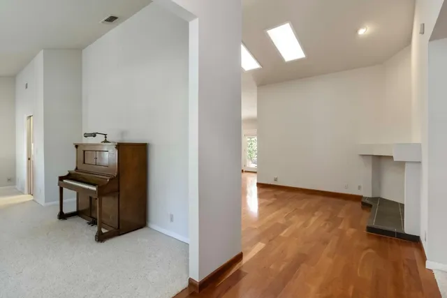 a living room with furniture and a piano