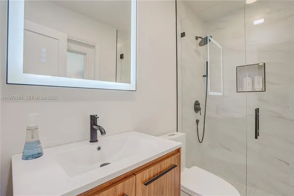 a bathroom with a sink and mirror