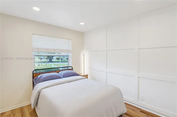 a bedroom with a large bed and a window