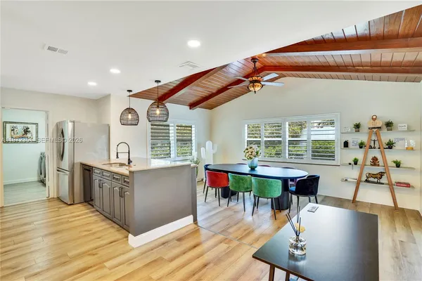 a large kitchen with a table and chairs in it