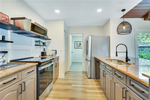 a kitchen with stainless steel appliances granite countertop a stove and a sink