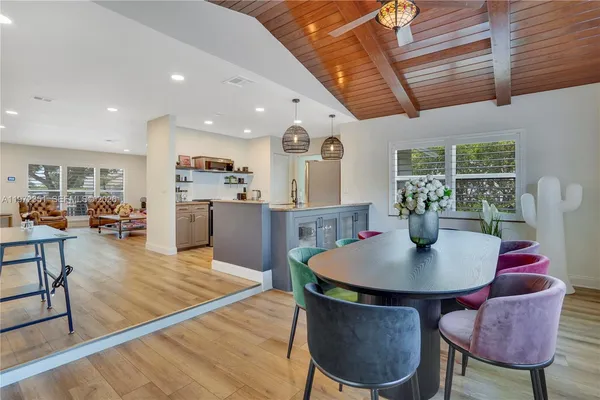 a living room with dining room and kitchen view