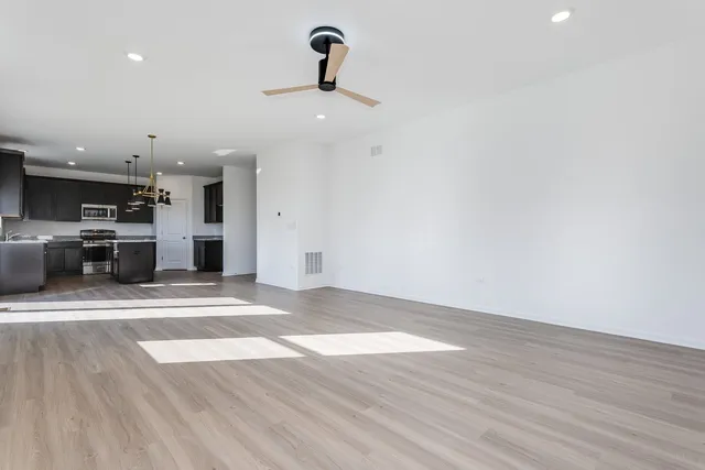 a view of a kitchen with a sink and a refrigerator