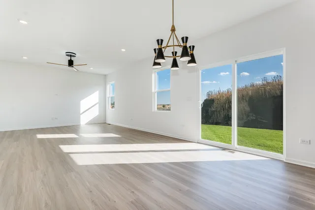 a view of a room with wooden floor and windows