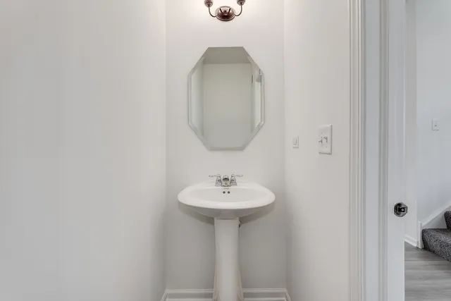 a bathroom with a sink a mirror and a