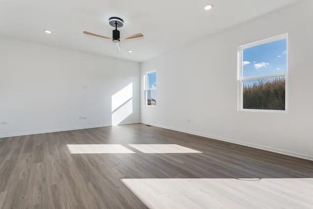 a view of a ceiling fan and wooden floor