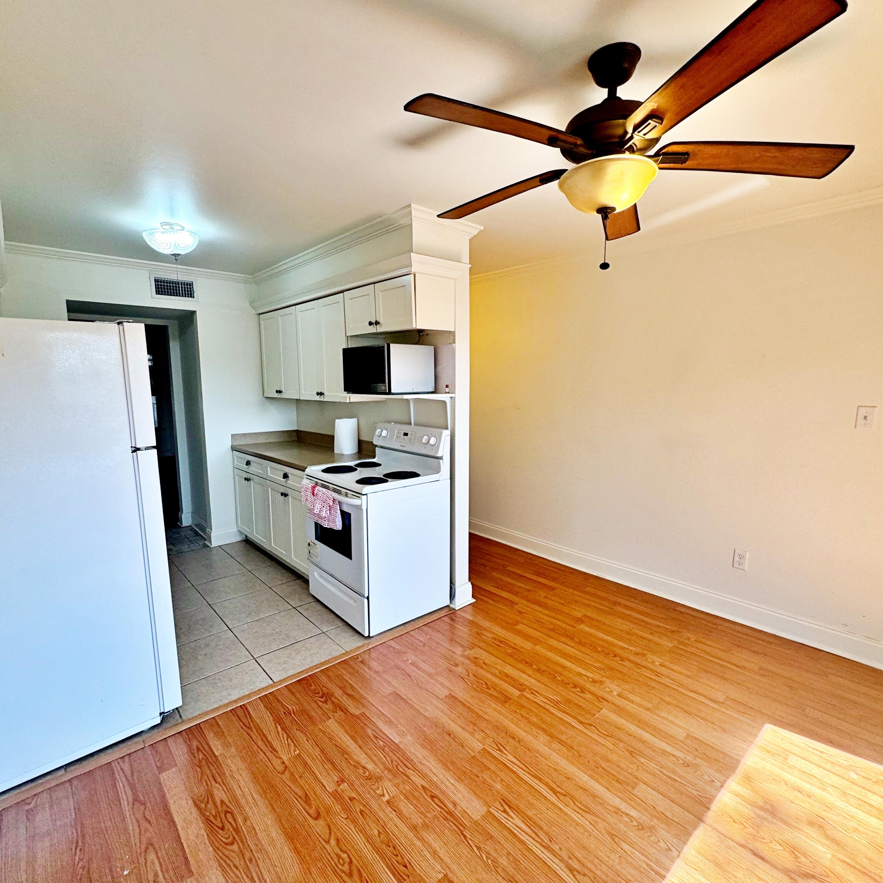 210 Pelham Road, Unit 215B Fort Walton Beach, FL 32547 - Photo 8 of 23 a kitchen with stainless steel appliances a refrigerator and a stove top oven
