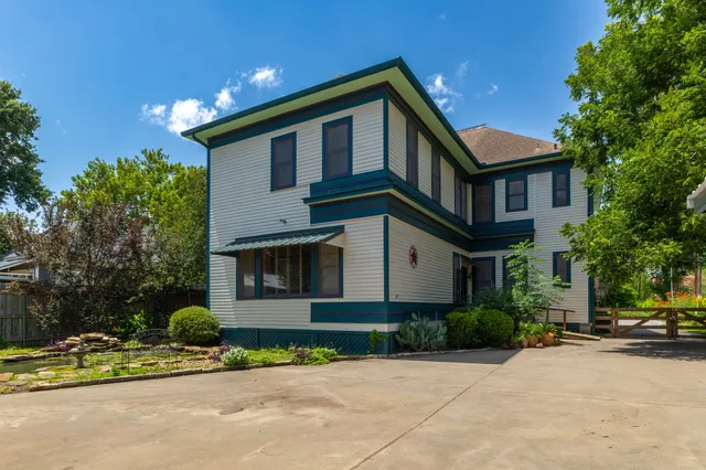 a front view of a house with swimming pool having outdoor seating