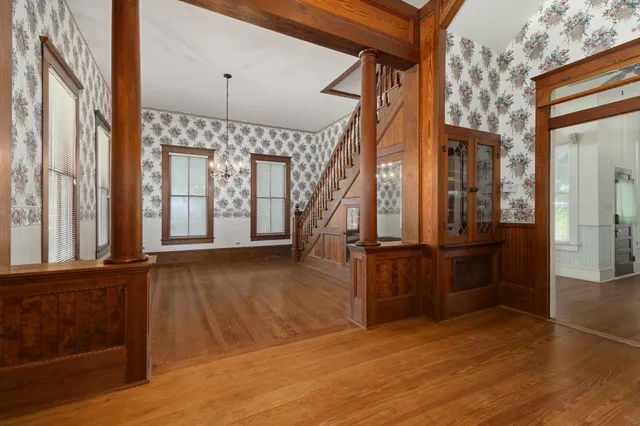 a view of an entryway with wooden floor and door