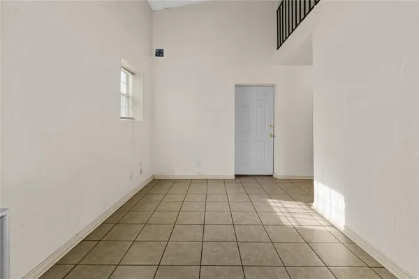 an empty room with white walls and tiles