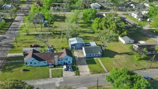 an aerial view of a house with a yard and lake view