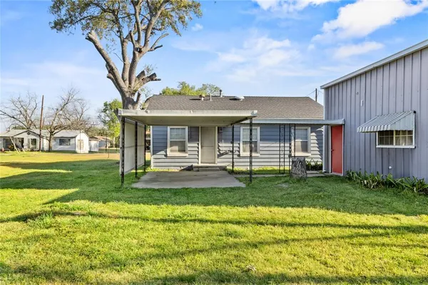 a front view of a house with a yard table and chairs