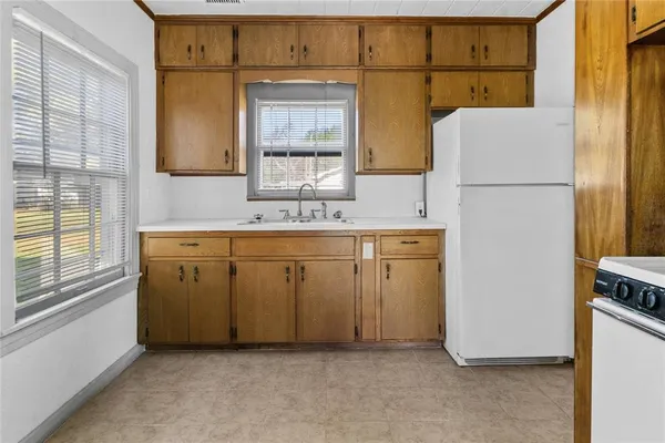 a utility room with cabinets washer and dryer